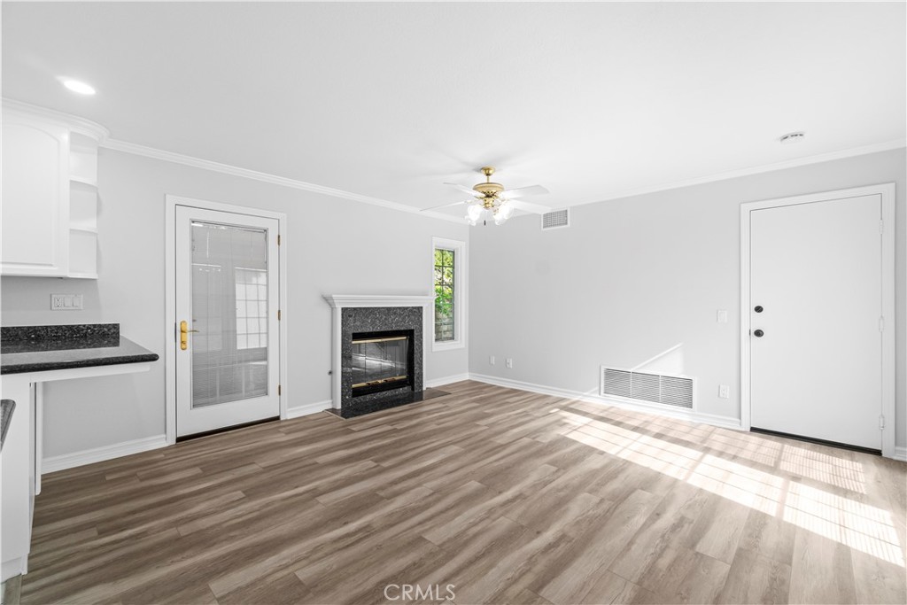 26433 Emerald Dove Drive Valencia, CA 91355 - Photo 10 of 50 a view of an empty room with wooden floor and a kitchen