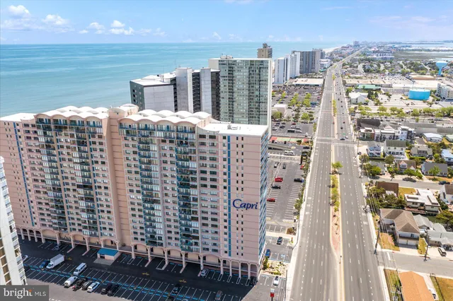 a dining hall with stainless steel appliances kitchen island granite countertop a table and chairs