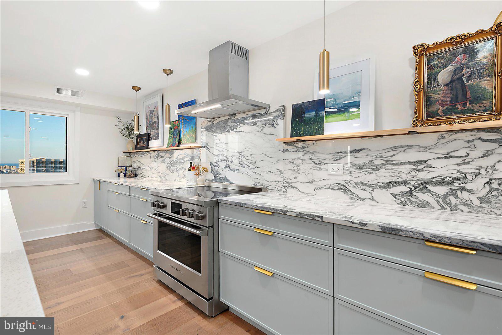 11000 Coastal Highway, Unit 2000 Ocean City, MD 21842 - Photo 23 of 102 a kitchen with stainless steel appliances granite countertop a stove a sink and a microwave
