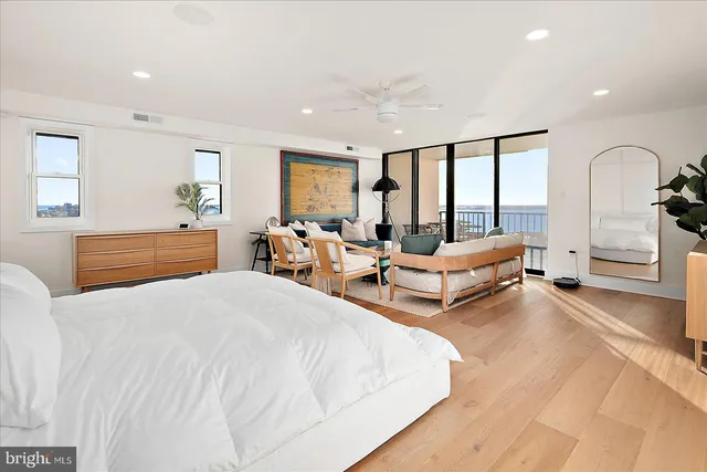 a spacious bedroom with a bed and a dresser