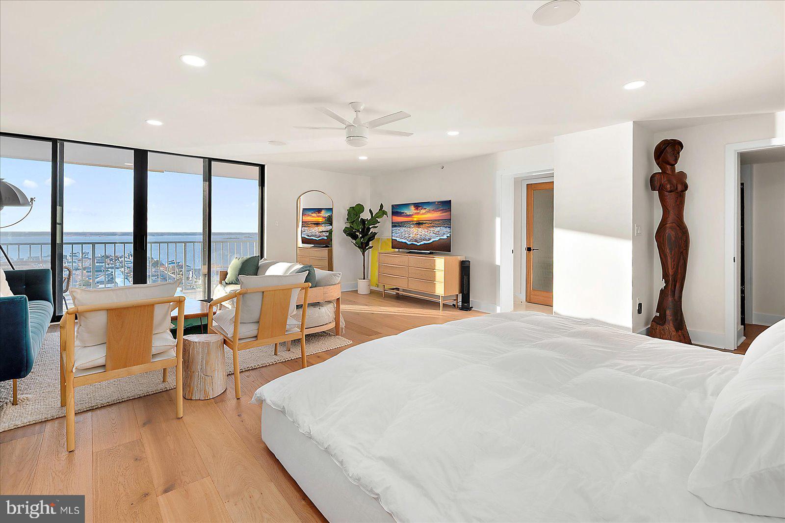 11000 Coastal Highway, Unit 2000 Ocean City, MD 21842 - Photo 38 of 102 a spacious bedroom with a large bed and a large window