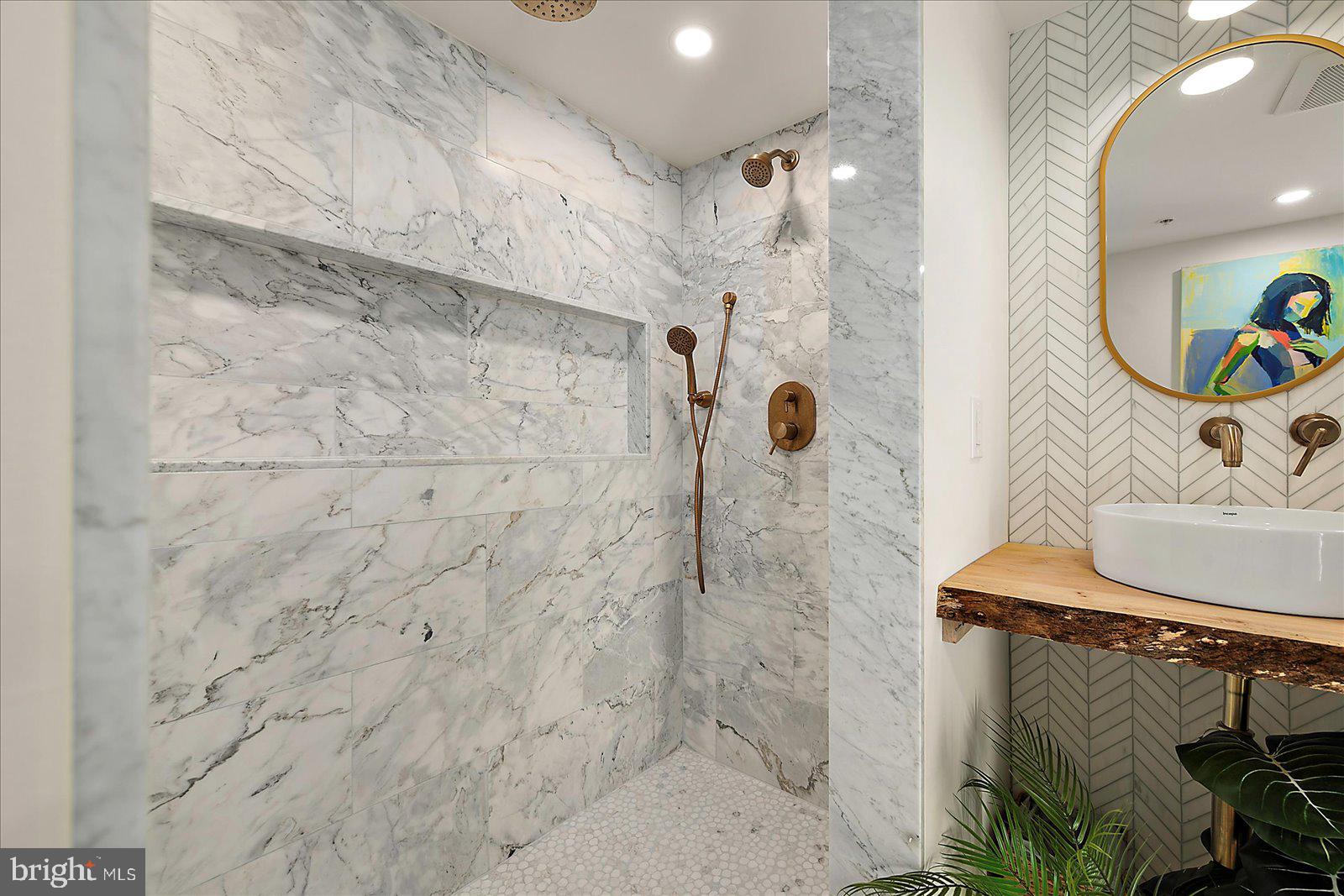 11000 Coastal Highway, Unit 2000 Ocean City, MD 21842 - Photo 45 of 102 a bathroom with a sink and a mirror