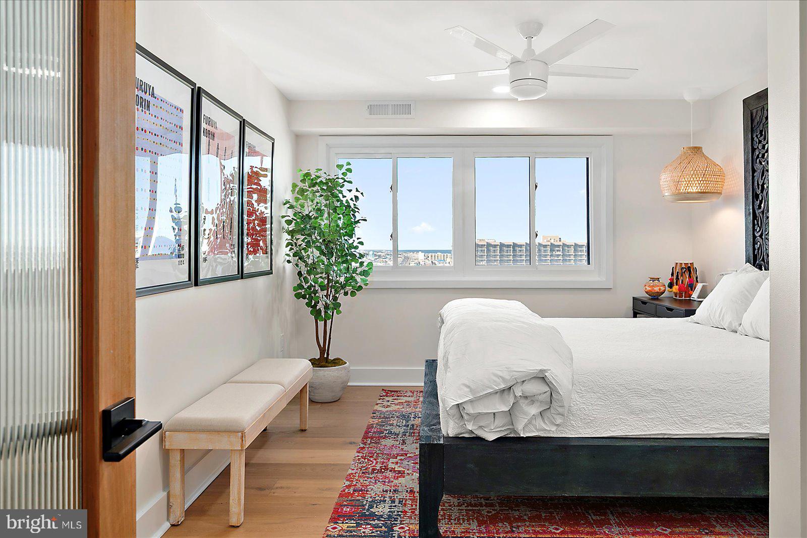 11000 Coastal Highway, Unit 2000 Ocean City, MD 21842 - Photo 48 of 102 a bedroom with a bed and a potted plant