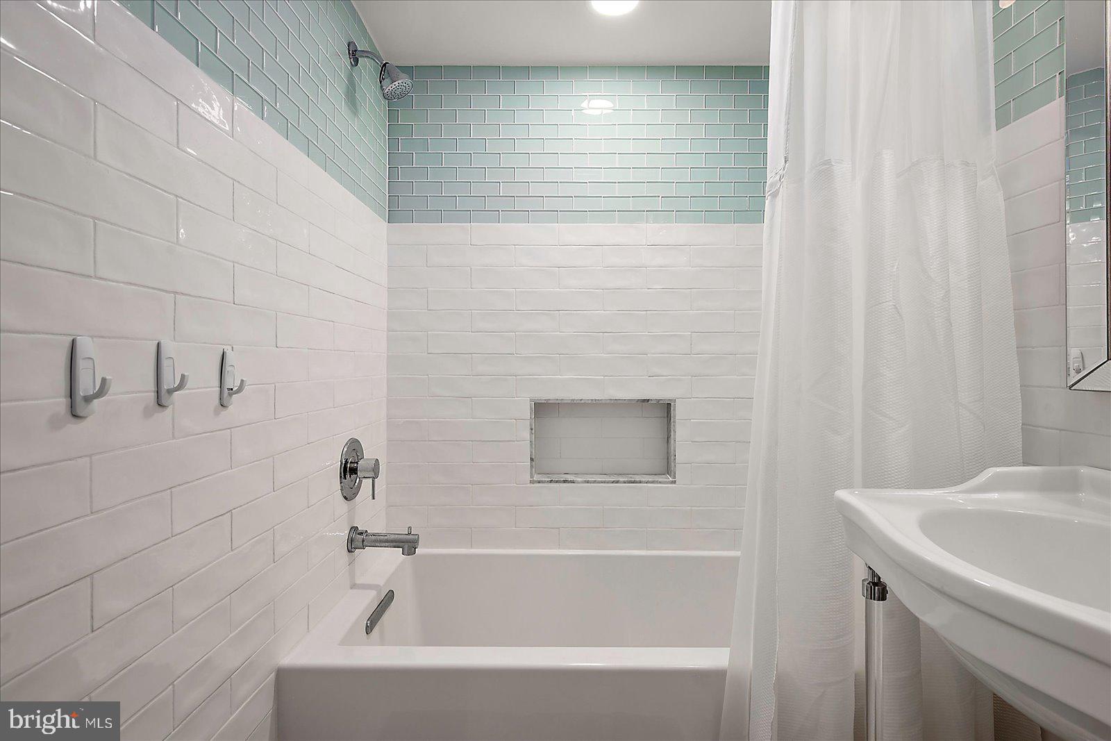 11000 Coastal Highway, Unit 2000 Ocean City, MD 21842 - Photo 56 of 102 a bathroom with a sink and a bathtub