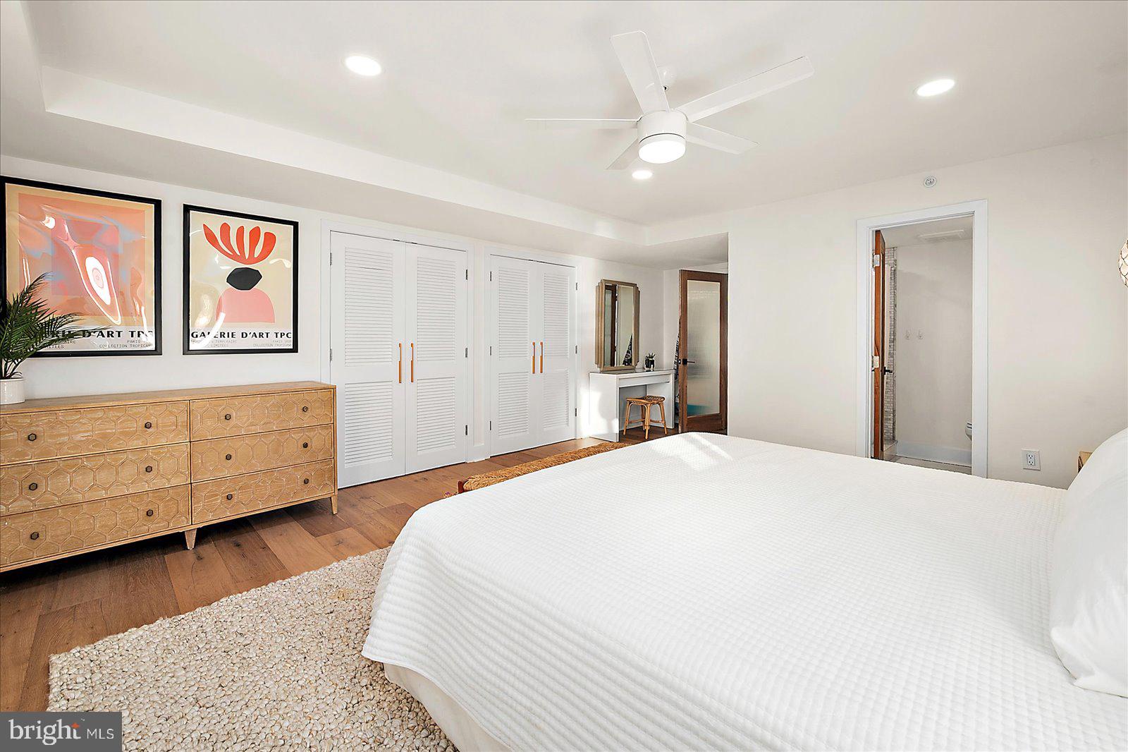 11000 Coastal Highway, Unit 2000 Ocean City, MD 21842 - Photo 59 of 102 a spacious bedroom with a bed and a dresser