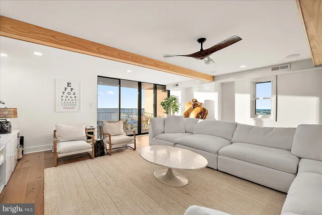 a living room with furniture a fireplace and a large window