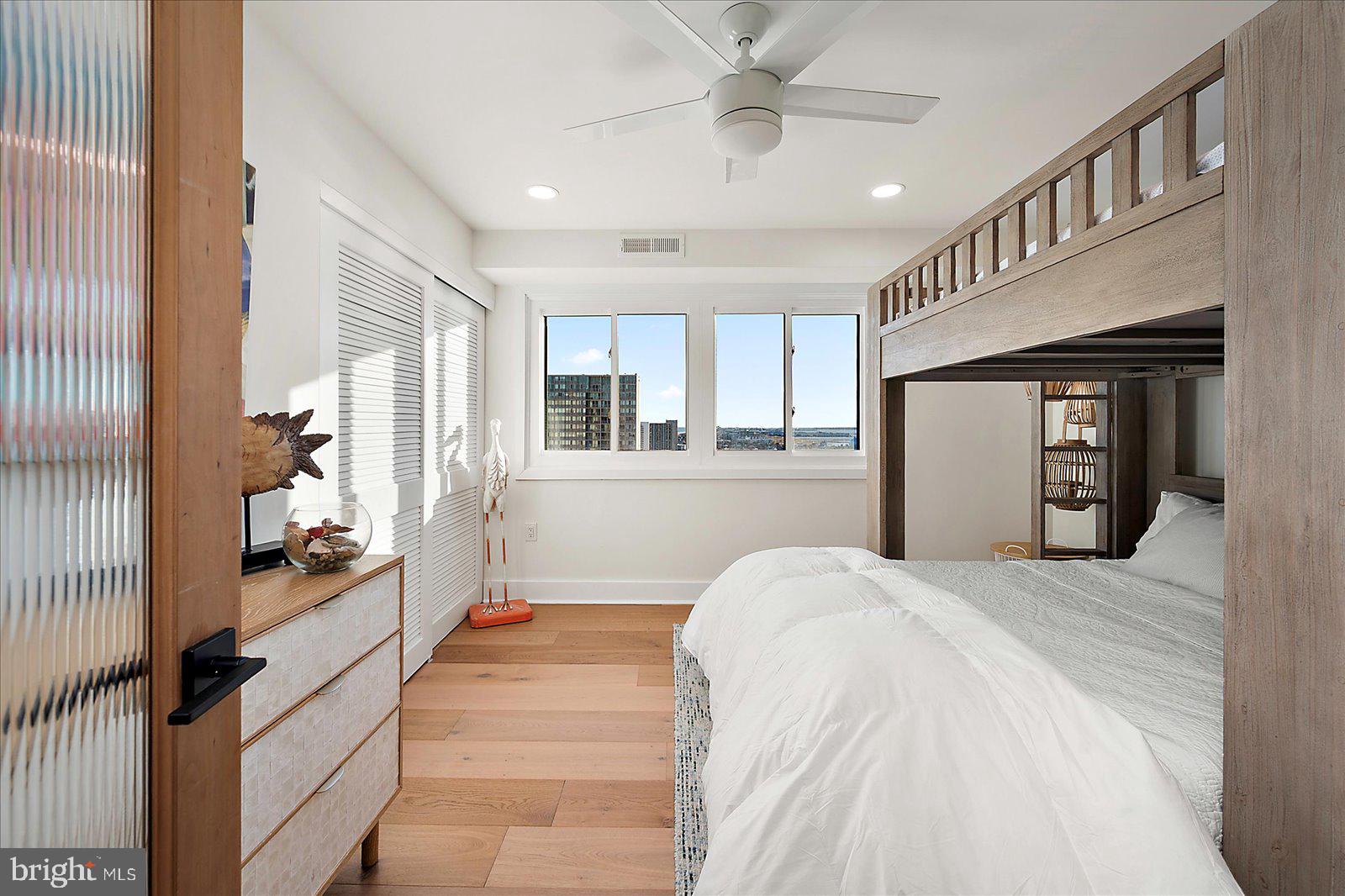 11000 Coastal Highway, Unit 2000 Ocean City, MD 21842 - Photo 69 of 102 a large bedroom with a large bed a chandelier and windows