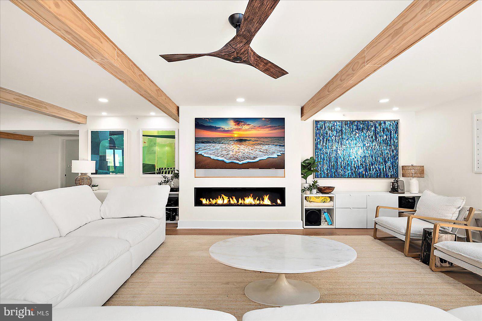 11000 Coastal Highway, Unit 2000 Ocean City, MD 21842 - Photo 10 of 102 a living room with furniture a fireplace and a large window