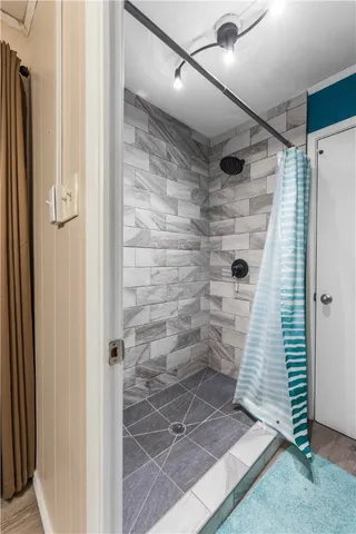 a bathroom with a glass door shower
