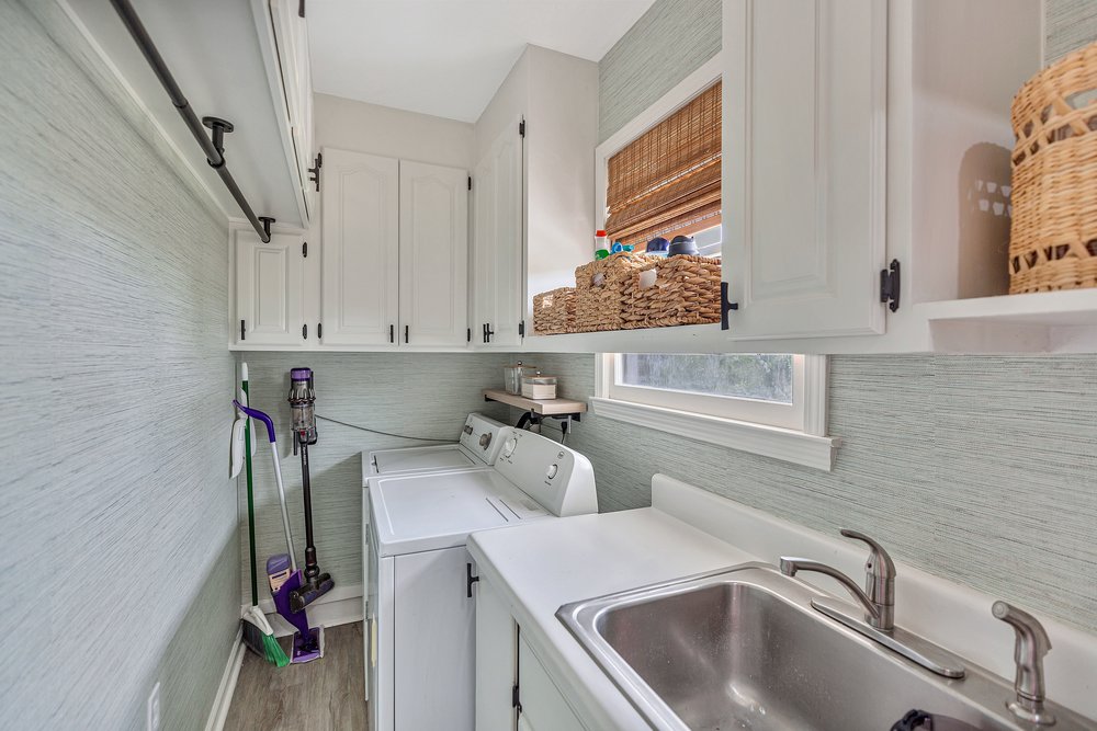 2310 Hannah Road Anderson, SC 29621 - Photo 26 of 32 Functional laundry room featuring a utility sink and ample cabinetry for organized storage.