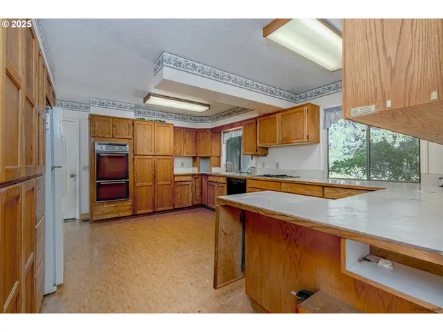 a view of a kitchen with a sink and cabinets