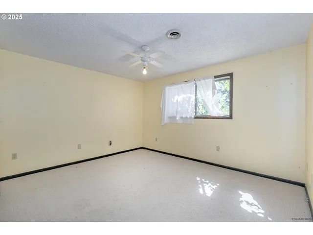 a bathroom with a granite countertop sink toilet a mirror and shower