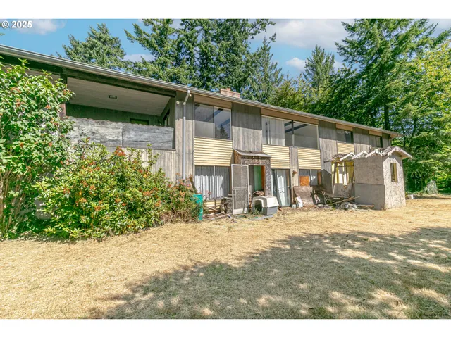 a yellow house with trees in front of it