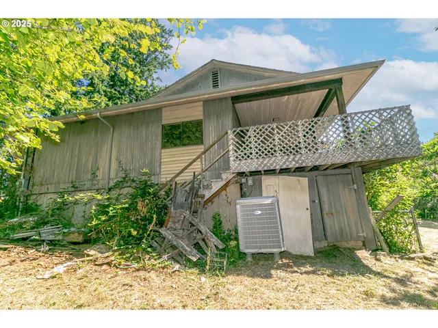 a view of a room with wooden floor and large windows