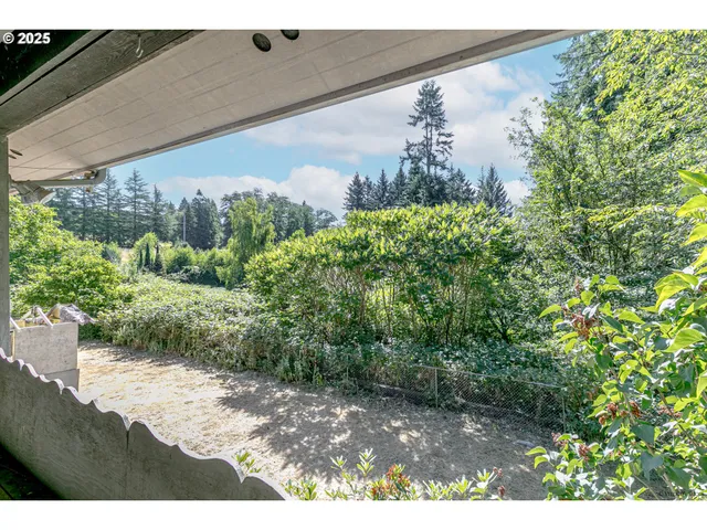 a view of a room with furniture and a window