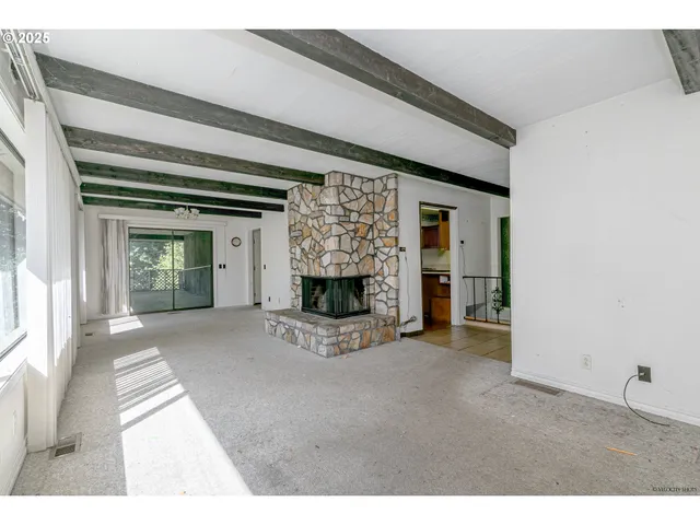a view of an empty room and fire place