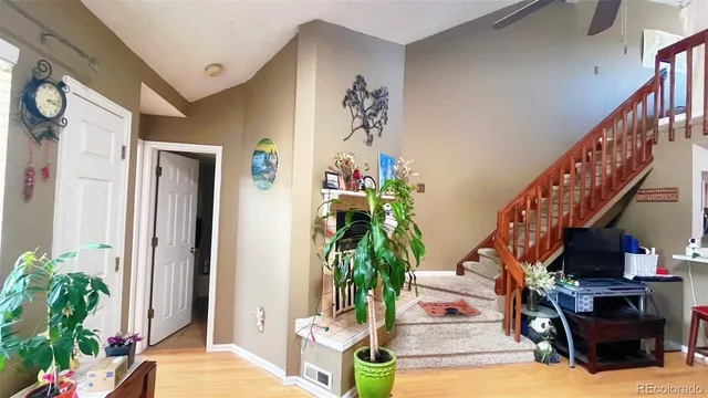 a living room with furniture and flower potted plants
