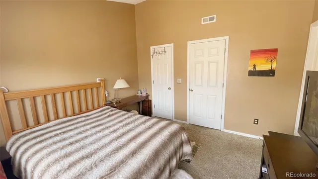 a bedroom with a bed and chair