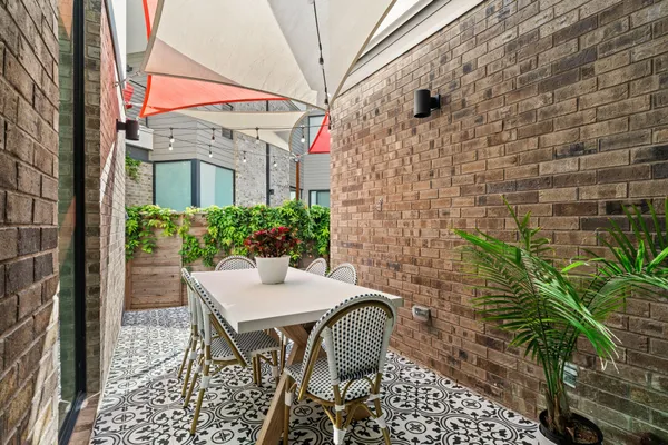 a view of a patio with a table and chairs