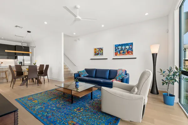 a living room with furniture a rug and a potted plant
