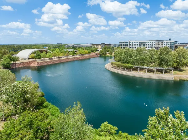 a view of a lake with houses in back