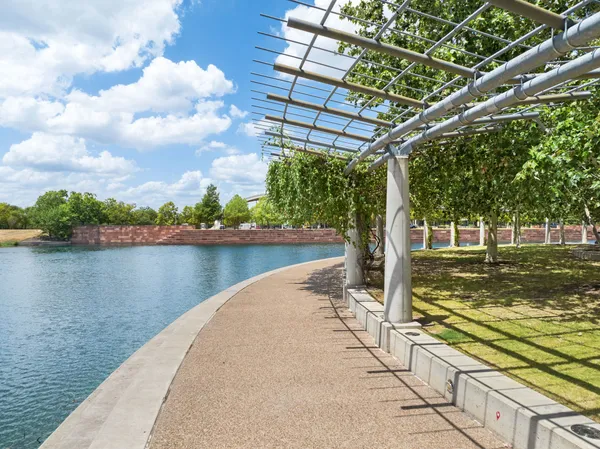 a view of a swimming pool with a patio and a yard