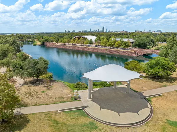an aerial view of a house with a yard and lake view