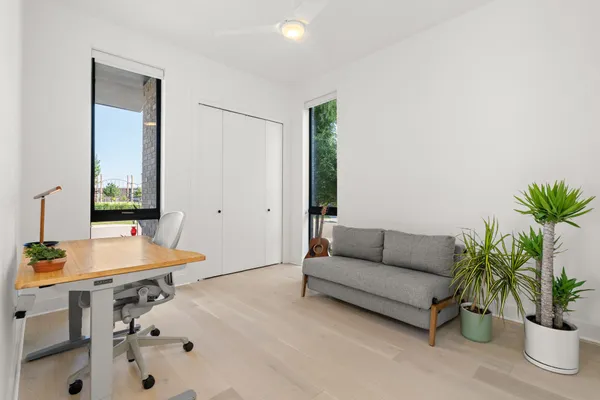 a living room with furniture and flowers