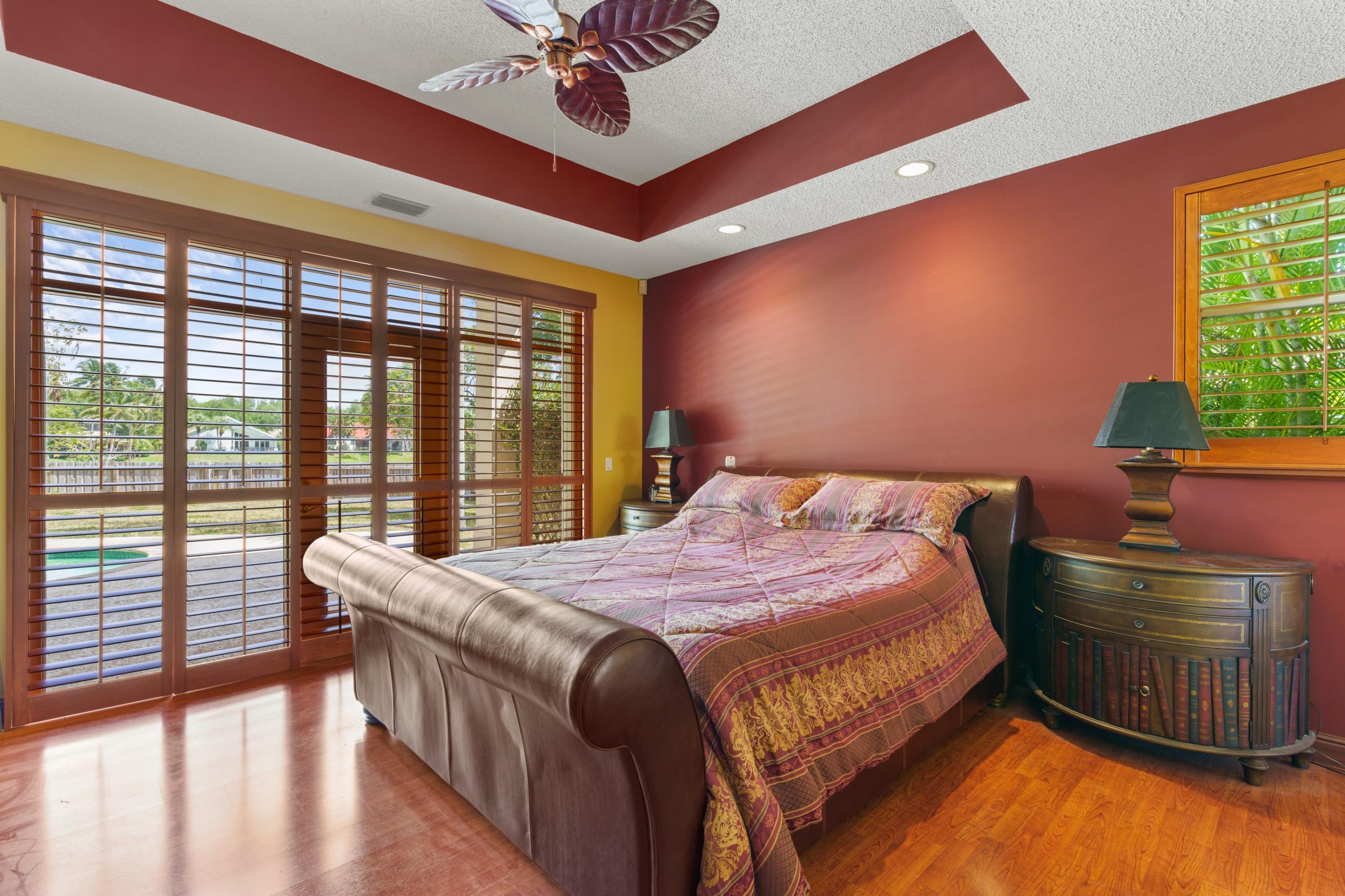 2687 Northwest 39th Street Boca Raton, FL 33434 - Photo 12 of 34 a bedroom with a bed and a large window