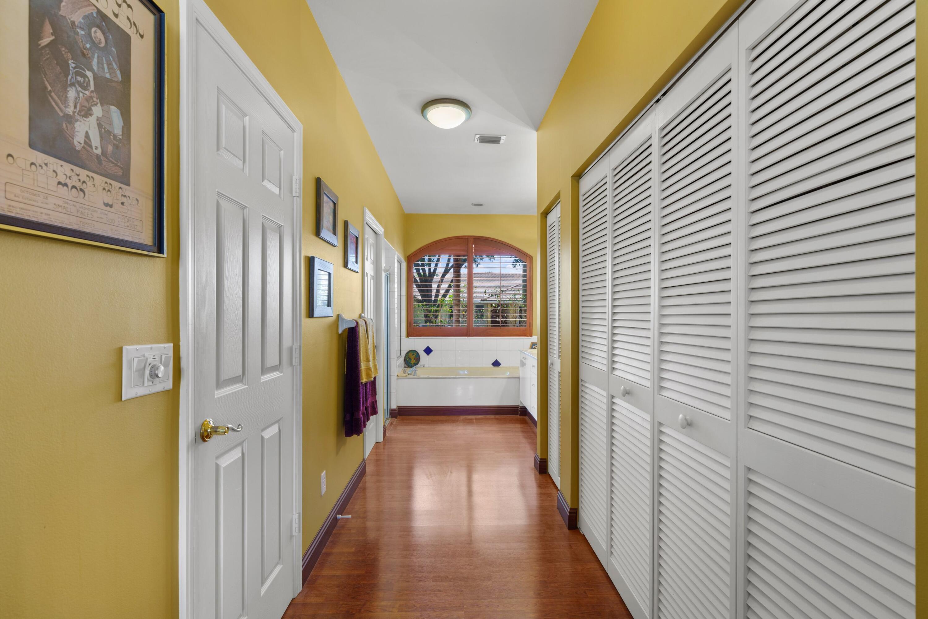 2687 Northwest 39th Street Boca Raton, FL 33434 - Photo 13 of 34 a view of a hallway with wooden shelves