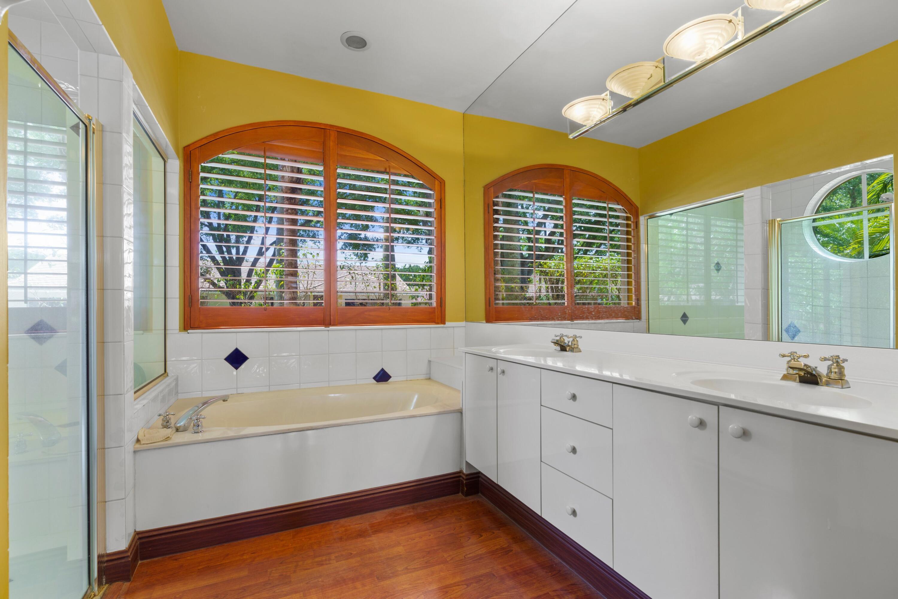2687 Northwest 39th Street Boca Raton, FL 33434 - Photo 14 of 34 a bathroom with a tub sink and mirror