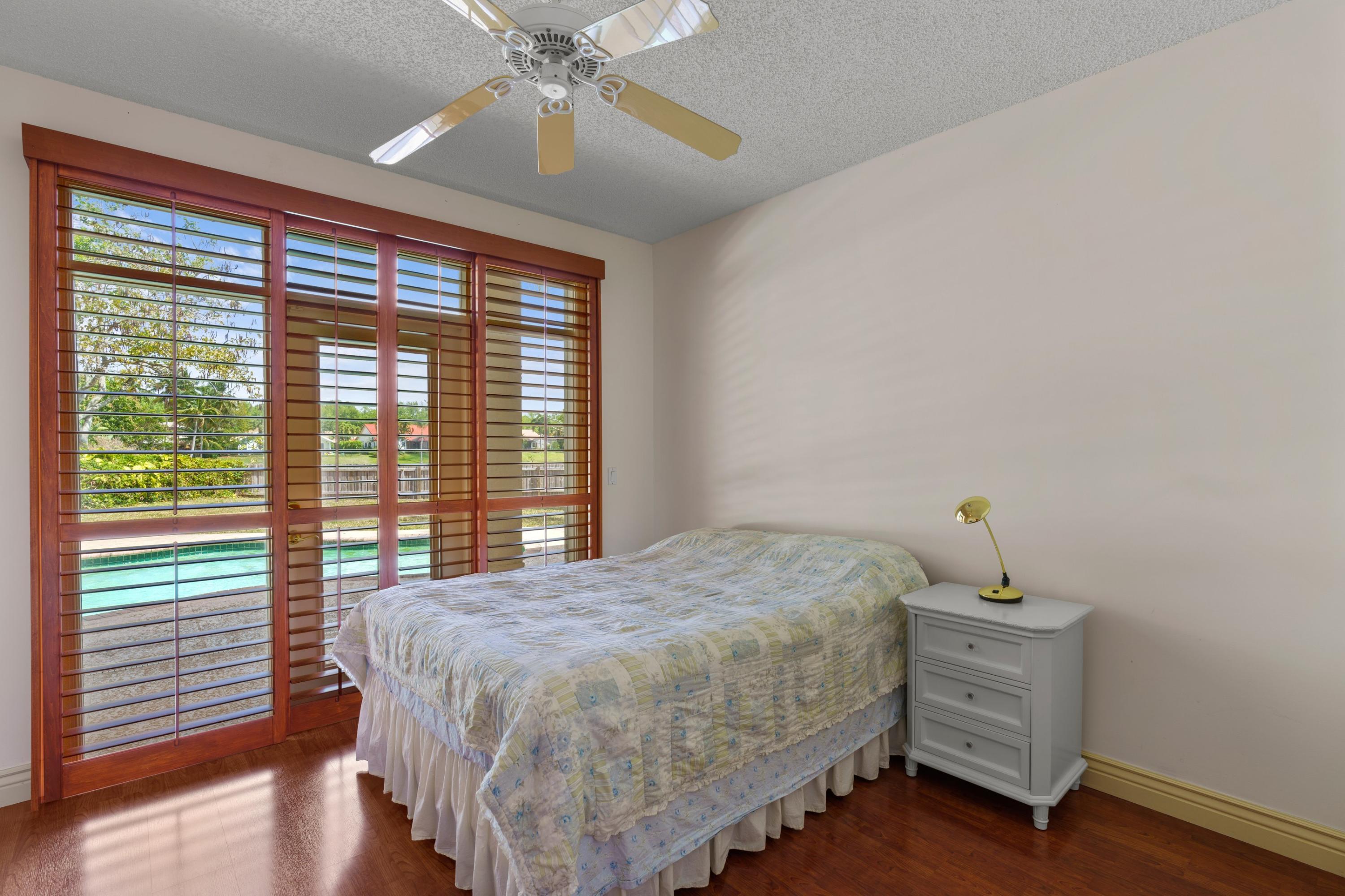 2687 Northwest 39th Street Boca Raton, FL 33434 - Photo 15 of 34 a bedroom with a bed and a window