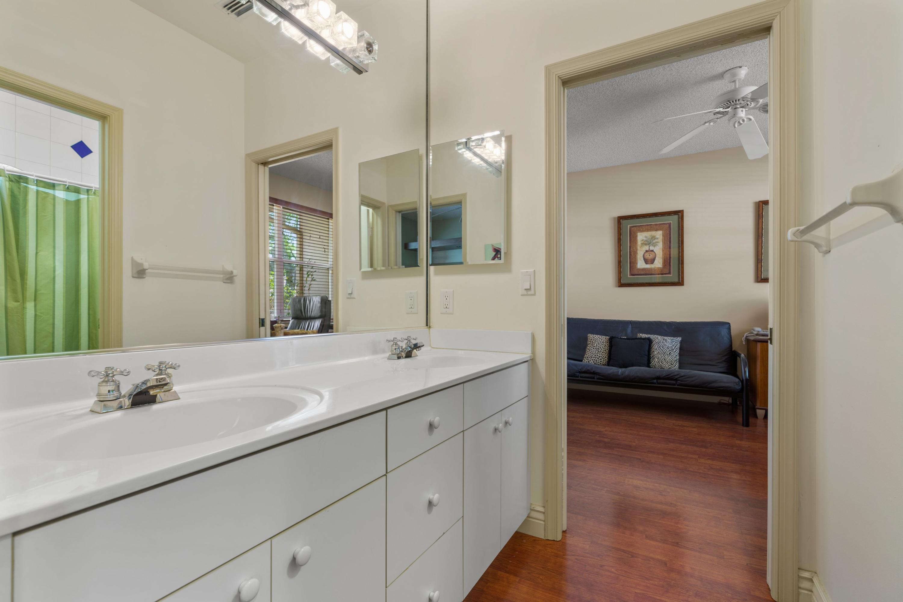 2687 Northwest 39th Street Boca Raton, FL 33434 - Photo 18 of 34 a en suite bathroom with a double vanity sink and mirror