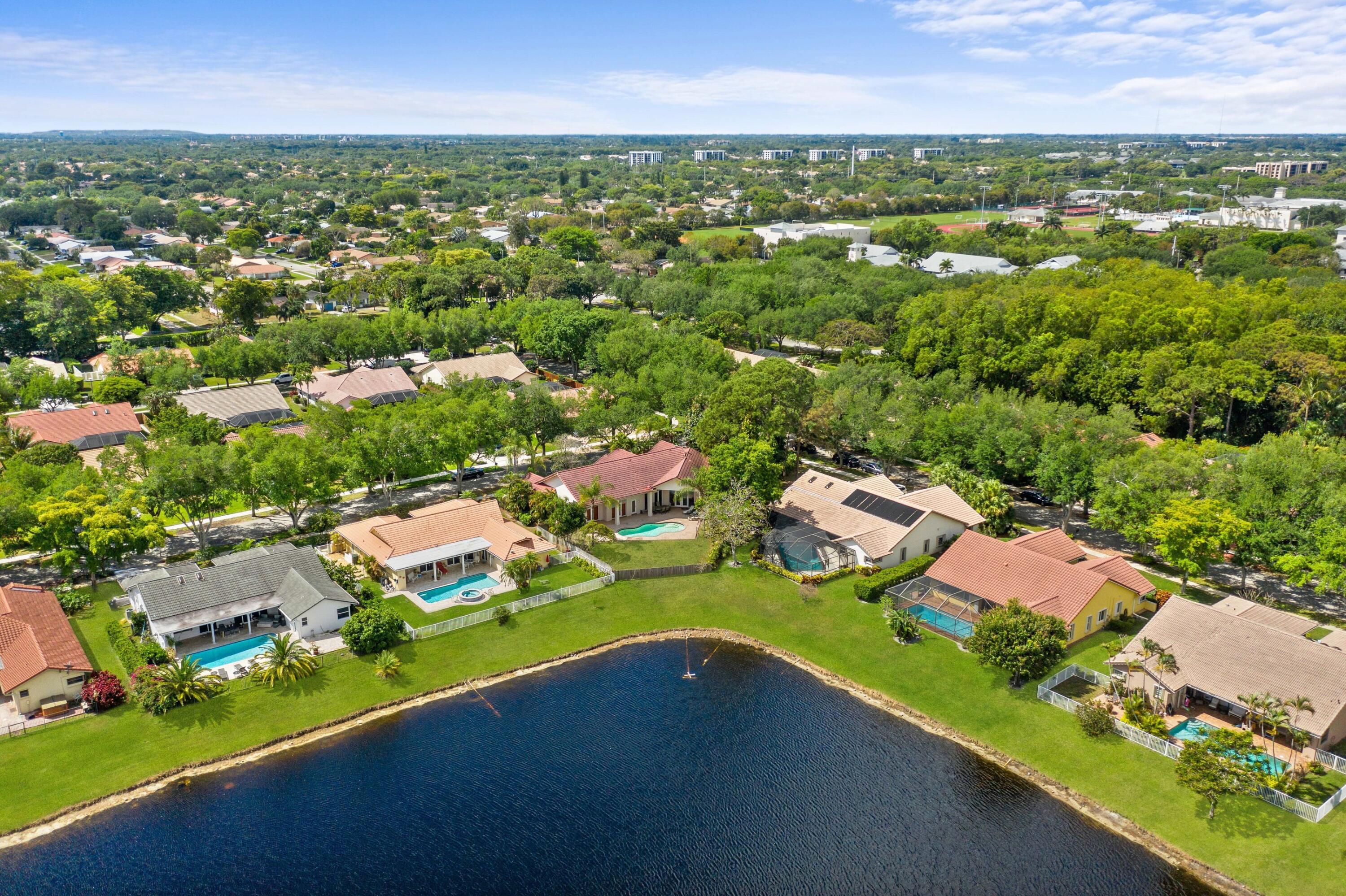 2687 Northwest 39th Street Boca Raton, FL 33434 - Photo 4 of 34 an aerial view of a houses with a garden and lake view