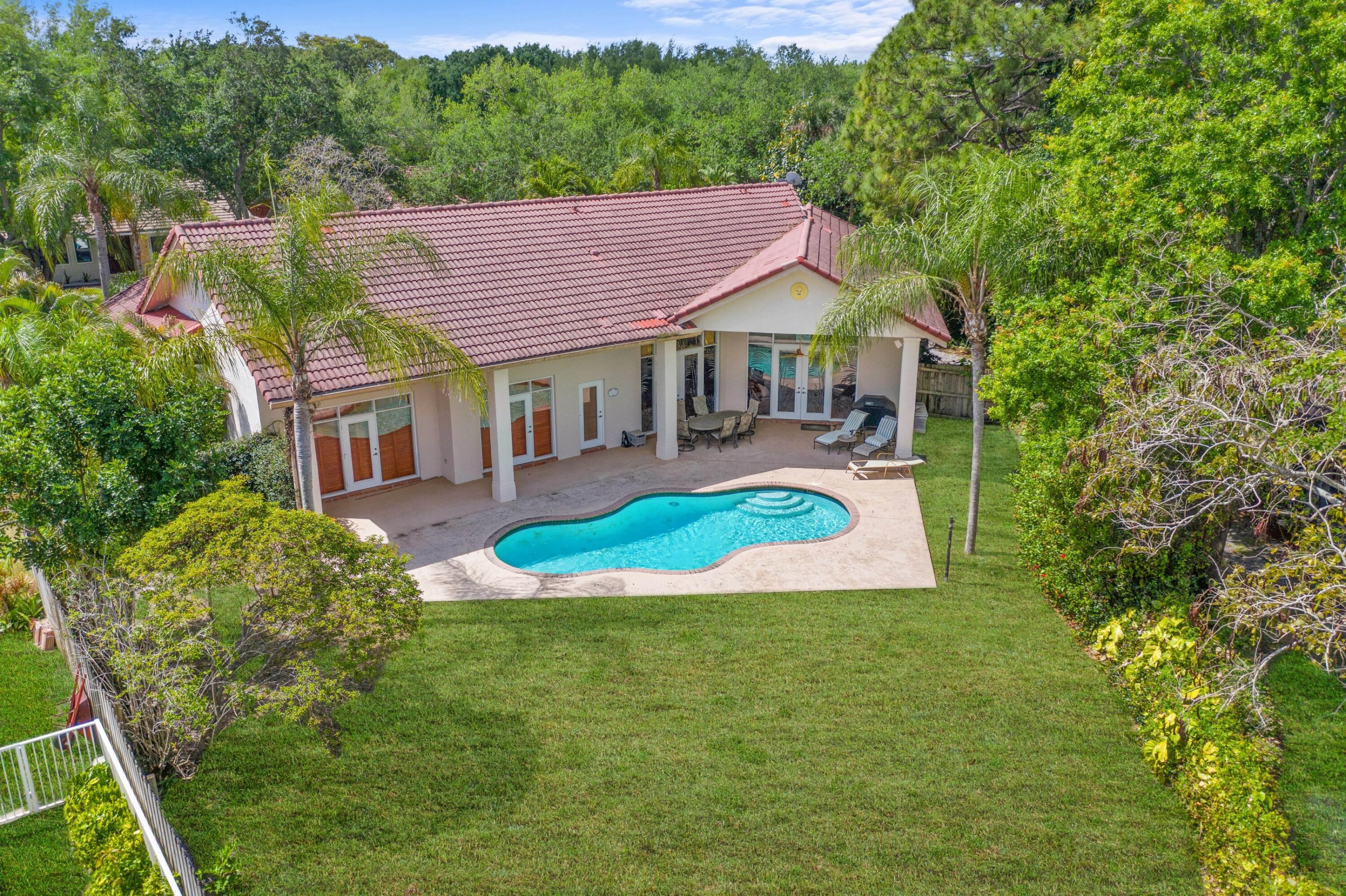 2687 Northwest 39th Street Boca Raton, FL 33434 - Photo 5 of 34 a view of a house with pool and a yard