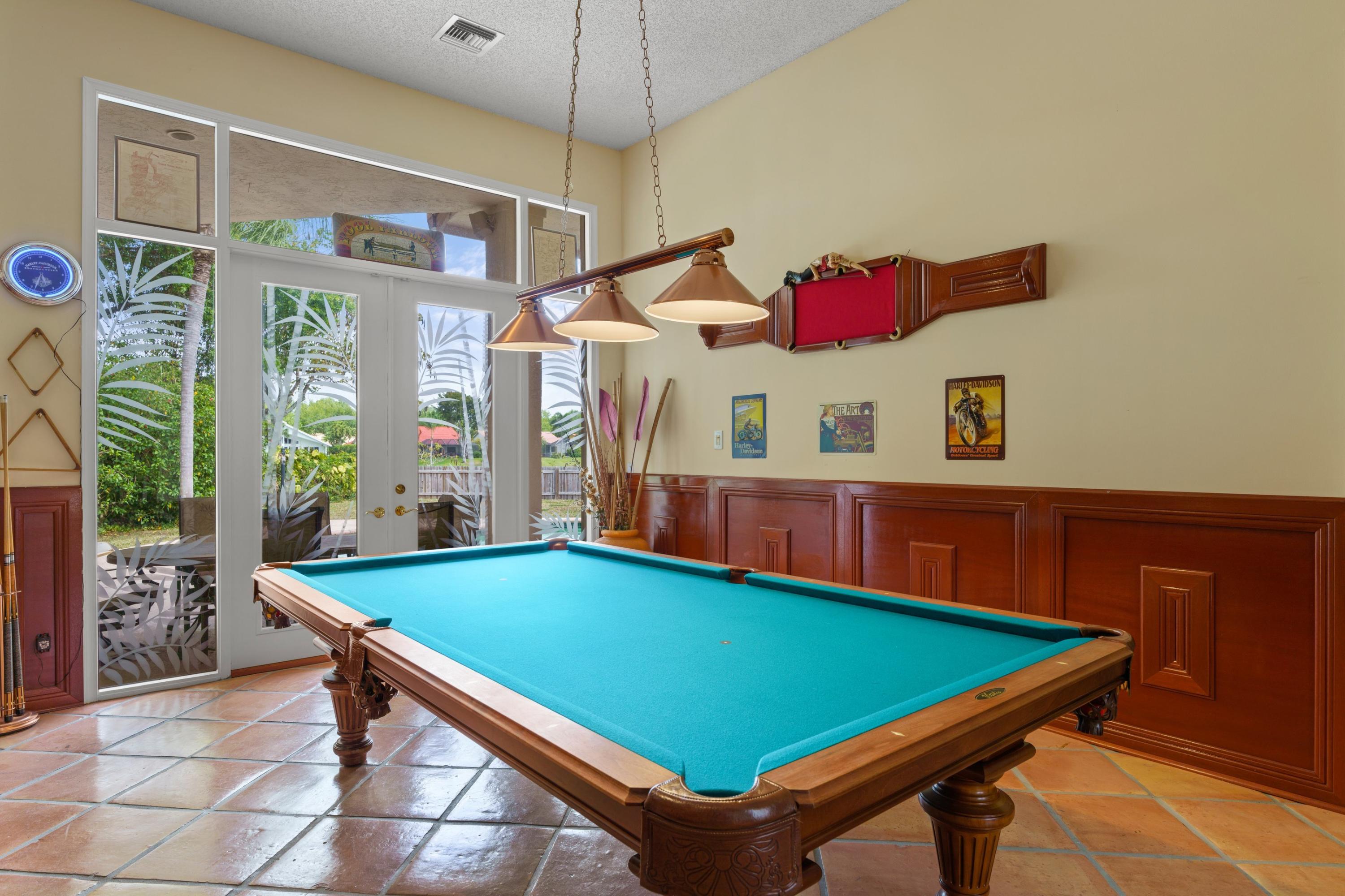 2687 Northwest 39th Street Boca Raton, FL 33434 - Photo 9 of 34 a room with pool table and windows