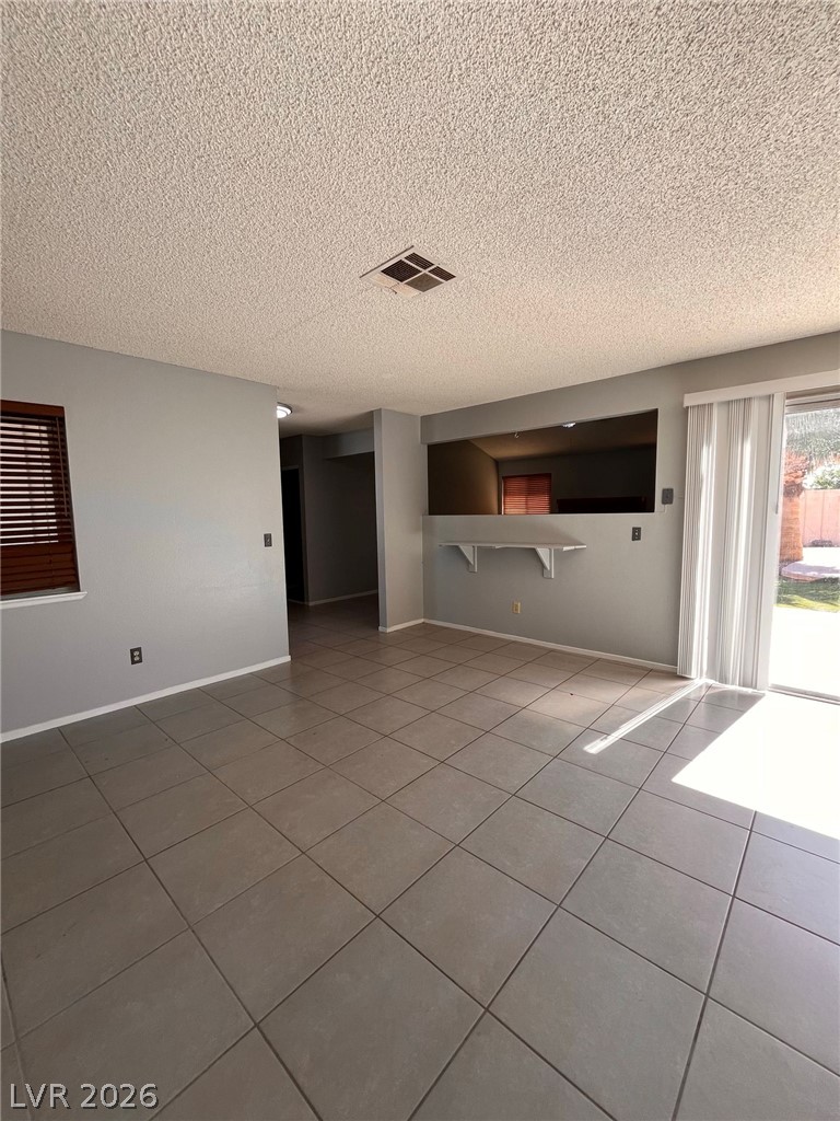 5348 Ravendale Circle Las Vegas, NV 89120 - Photo 7 of 14 Natural light illuminates this living space with its tile flooring and direct outdoor access.