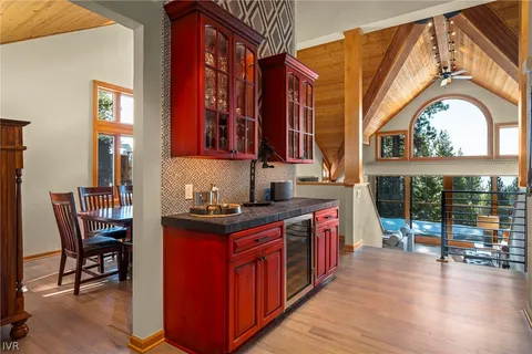 a kitchen with stainless steel appliances granite countertop a stove a sink and a wooden floors