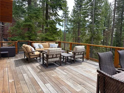 a view of sitting area on roof deck with furniture