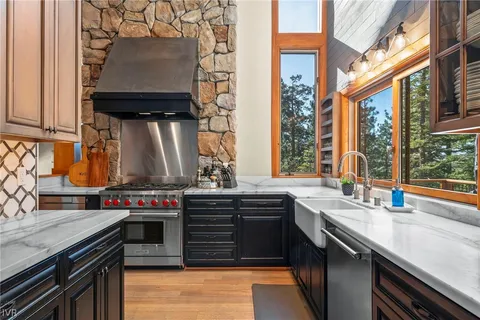 an outdoor kitchen with a stove and a sink