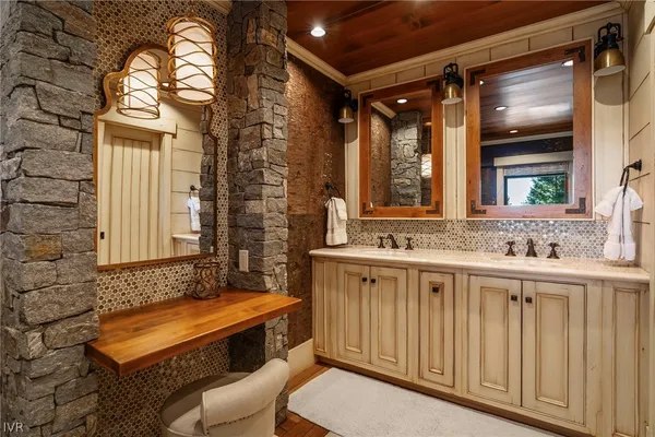 a bathroom with a toilet a sink and a large mirror