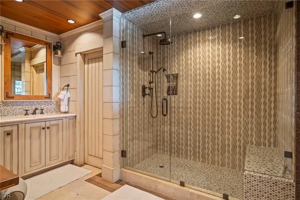 a bathroom with a shower and a sink