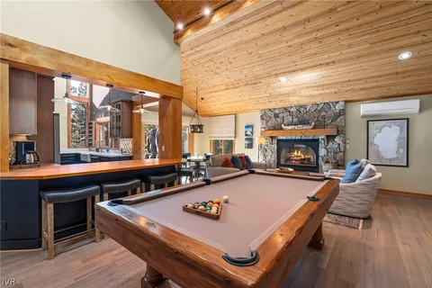 a living room with furniture a fireplace and a table