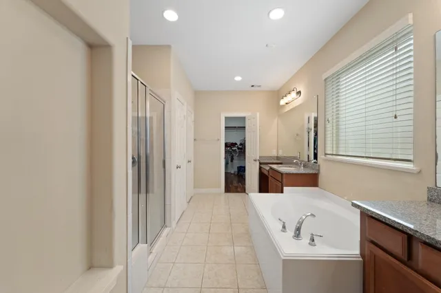 a bed room with a bed and a ceiling fan