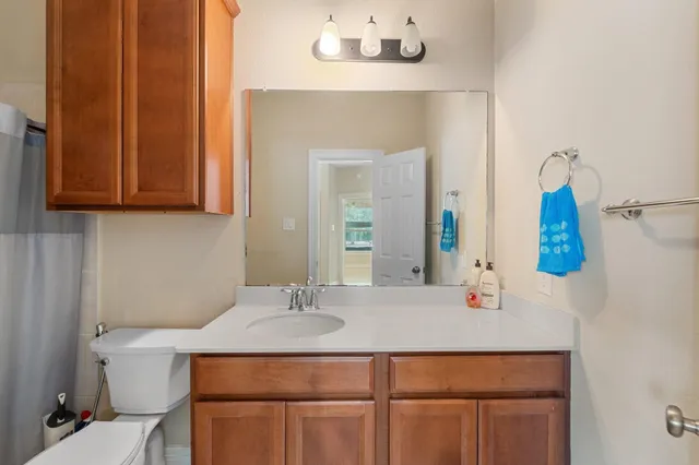 a view of a hallway with wooden floor and closet area