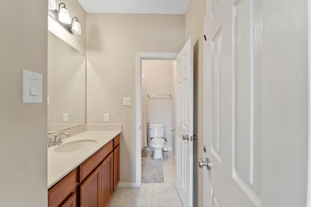 a bedroom with a bed a desk and chair