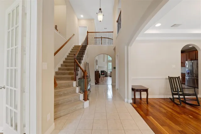 a view of entryway and hall with wooden floor