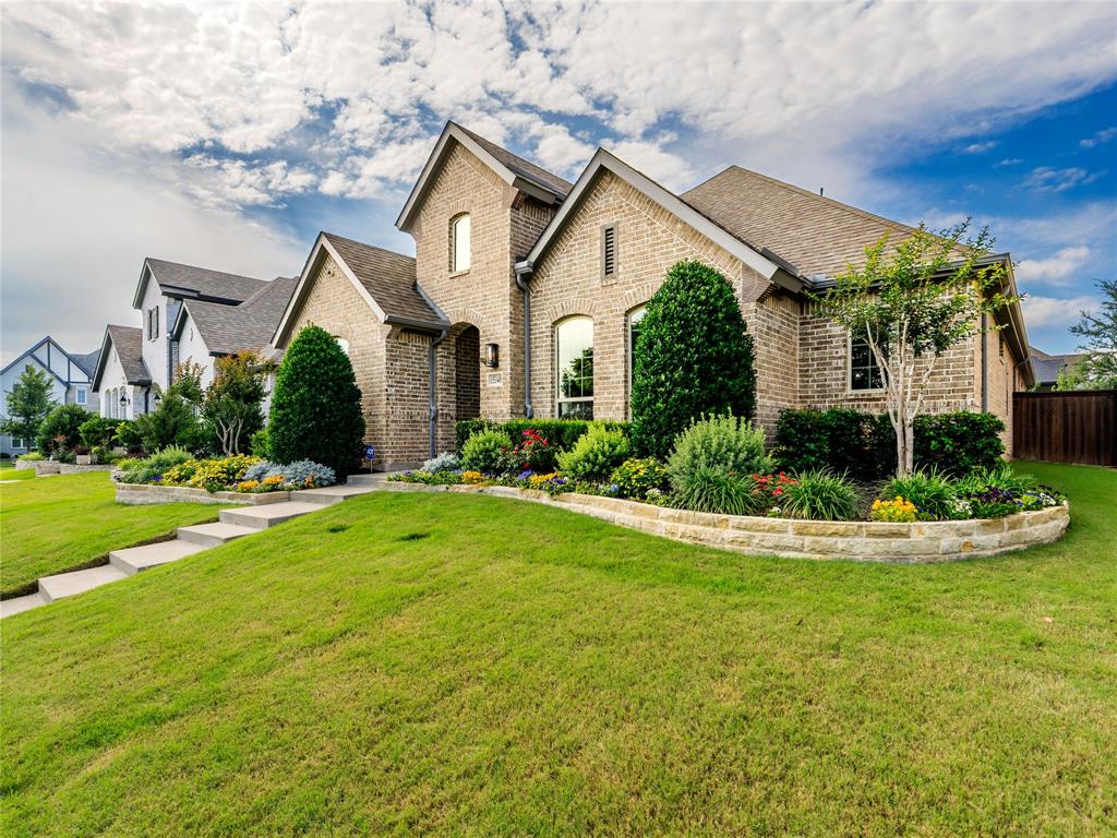 15340 Crape Myrtle Road Frisco, TX 75035 - Photo 37 of 40 Brick exterior featuring an arched entry, a prominent front gable, and a decorative window