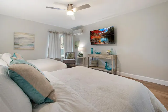 a bedroom with a bed and a flat screen tv