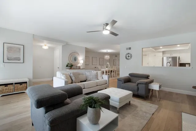 a living room with furniture and wooden floor